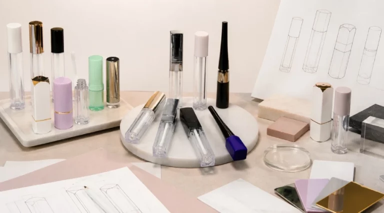 White-label lip gloss tubes and lipstick cases displayed with packaging sketches and finish samples